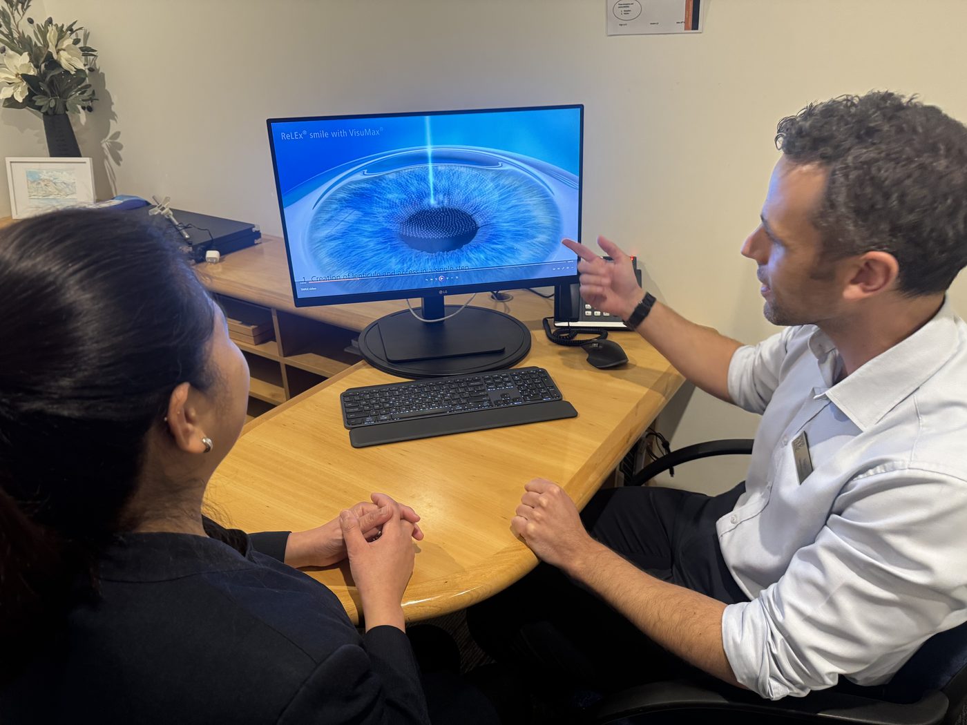 A member of our technical team talking a patient through vision correction at Fendalton Eye Clinic